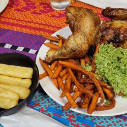 Peruvian Chicken - 1/2 chicken with 2 sides - sweet potatoes & cilantro rice.   Fried cassava added in for the picture.