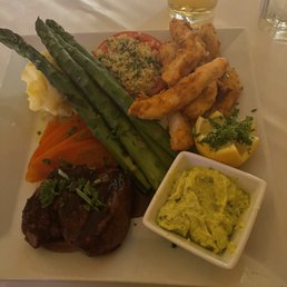 Beef with calamari , asparagus, potatoes, carrots and tomato.