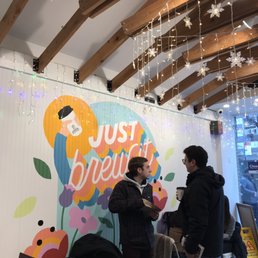 two people standing in a coffee shop