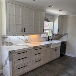 Stone Crafters - Quartz countertops with corresponding quartz backsplash, waterfalls, and window surround!