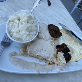 Another Broken Egg Cafe - The Biscuit and Gravy breakfast. Two eggs, two freshly made sausage patties and a side of grits! - Breakfast & Brunch Near Me - West Chester Township, Ohio