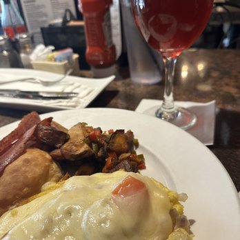 White Wolf Cafe - Build Your Own Omelet, Home Fries, Turkey Bacon, Biscuit and Pomegranate mimosa - New American Near Me - Orlando, Florida White Wolf Cafe - Build Your Own Omelet, Home Fries, Turkey Bacon, Biscuit and Pomegranate mimosa - New American Near Me - Orlando, Florida