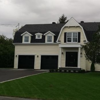 Pro Terrain - a large white house with black shutters - Landscaping Near Me - Saint-Bruno-de-Montarville, Quebec Pro Terrain - a large white house with black shutters - Landscaping Near Me - Saint-Bruno-de-Montarville, Quebec