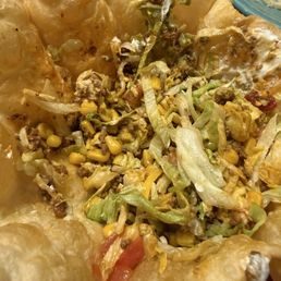 Taco salad LOADED with corn not listed on the menu.