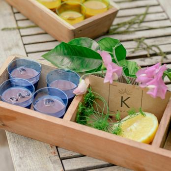 Kafei - a wooden box filled with glasses and lemon slices - Coffee & Tea Near Me Kafei - a wooden box filled with glasses and lemon slices - Coffee & Tea Near Me