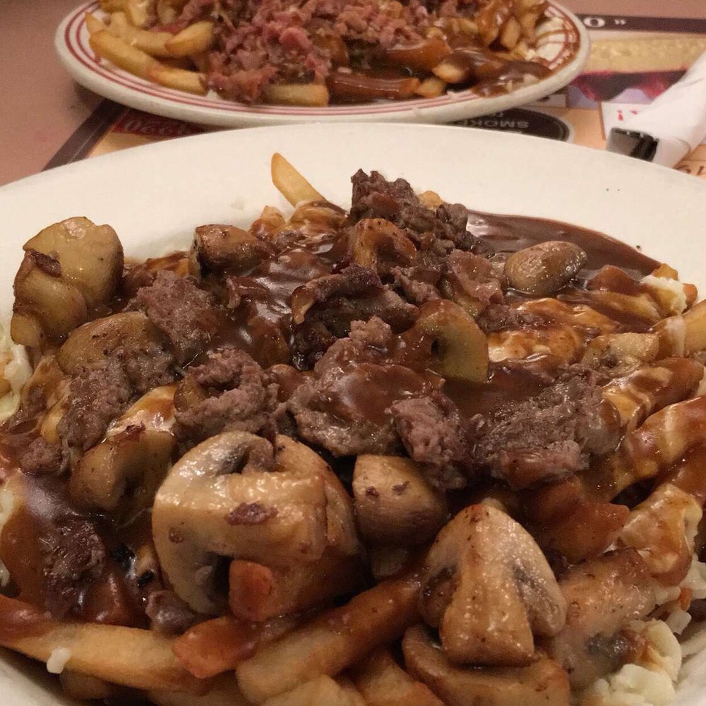 Poutine with minced beef and mushrooms Poutine with minced beef and mushrooms