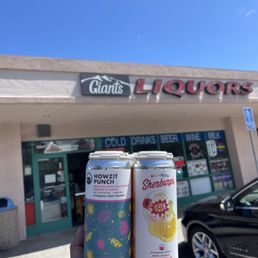 a hand holding two cans a hand holding two cans