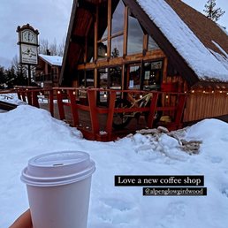 a hand holding a cup of coffee