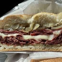Hot Roll with corned beef pastrami mozz cheese butter garlic and caramelized onions Hot Roll with corned beef pastrami mozz cheese butter garlic and caramelized onions