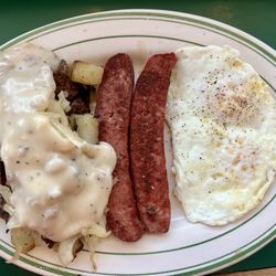 Sausage and eggs breakfast with Hot Louie sausage and gravy and onions on the potatoes (toast not shown).