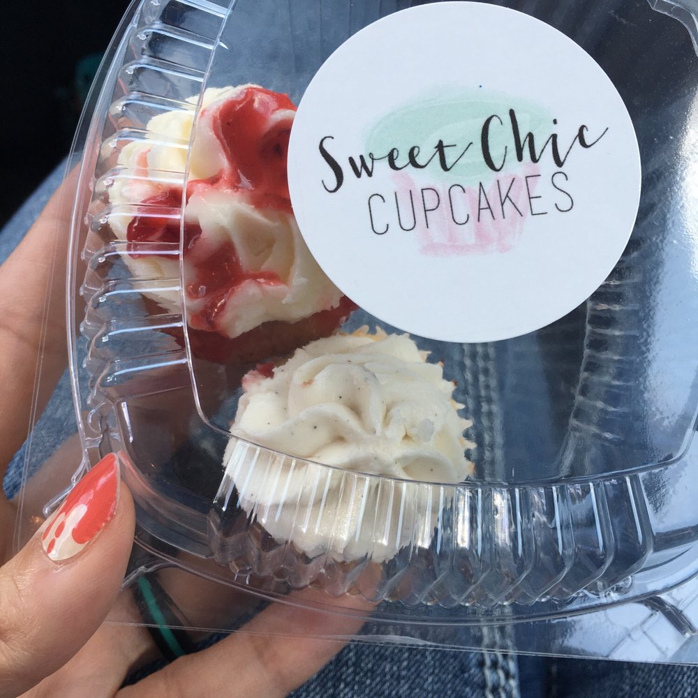 a hand holding a cupcake a hand holding a cupcake