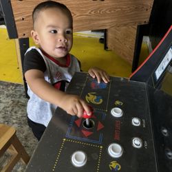 Gold Line Barber Shop - The play area has pac man, foosball, cars, trucks, a bike, books, and lots of other cool toys for kids to play with.