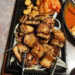 a plate of meat and vegetables with chopsticks a plate of meat and vegetables with chopsticks