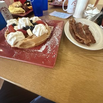 Toasted Mango Cafe - Belgium waffle fruit topped with a side of bacon and water - Cafes Near Me - Sarasota, Florida
