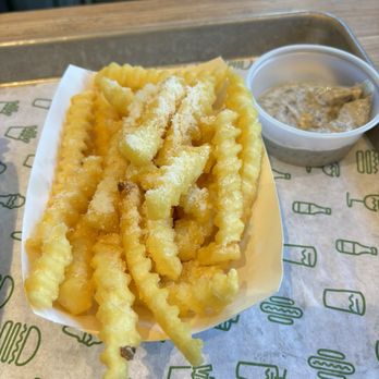 Shake Shack Perimeter Mall - Parmesan fries with a side of black truffle sauce. - Burgers Near Me - Atlanta, Georgia Shake Shack Perimeter Mall - Parmesan fries with a side of black truffle sauce. - Burgers Near Me - Atlanta, Georgia