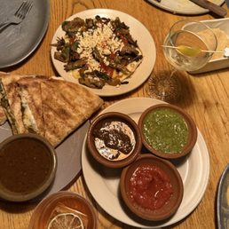 Quesadilla with veggies, a tostada with mushrooms and cheese, trip salsa and chips and some drinks