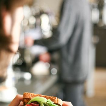 Patika Luncheonette - a man holding a sandwich - Cafes Near Me - Austin, Texas Patika Luncheonette - a man holding a sandwich - Cafes Near Me - Austin, Texas