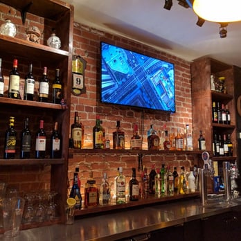 Idle On Bloor - a tv mounted on a brick wall - Lounges Near Me - Toronto, Ontario Idle On Bloor - a tv mounted on a brick wall - Lounges Near Me - Toronto, Ontario