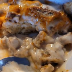Nichole's Coffee Depot & Deli - Biscuits and gravy with breakfast sausage and Cholula sauce.