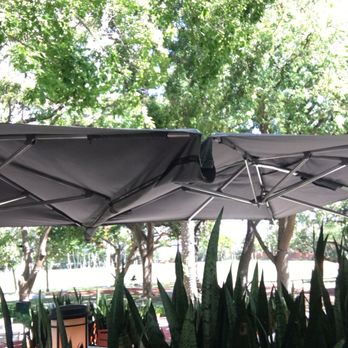 Glass & Vine - Restaurant does a great job Hiding the fans that keep the outside seating cool. - New American Near Me - Miami, Florida