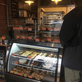 Brioche à Tête - a man standing in front of a bakery - Patisserie/Cake Shop Near Me - Montreal, Quebec Brioche à Tête - a man standing in front of a bakery - Patisserie/Cake Shop Near Me - Montreal, Quebec