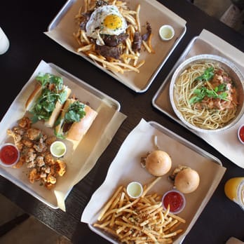 Nguyen's Kitchen - Left to right: bulgogi fries, crawfish pasta, sliders and Cajun fries, pork banh mi, popcorn chicken - Vietnamese Near Me - Orange, California