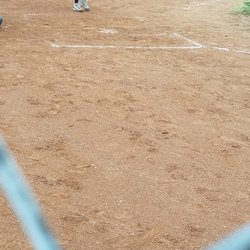 Buena Park National Little League - Home plate is trying to peak out to bad they don't make brushes for umpires to keep it clean.