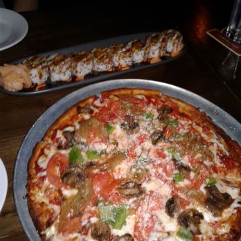 Lucky Strike Honolulu - Cauliflower veggie pizza. Cal roll behind it. - Arcades Near Me - Honolulu, Hawaii