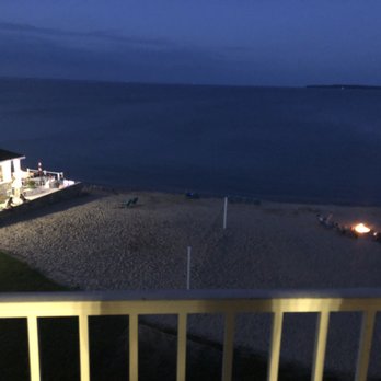 Breakers Resort - Night view of Lake Huron from our room. Beach fire pit to right, gas fire pit on deck in center. - Hotels Near Me - Saint Ignace, Michigan
