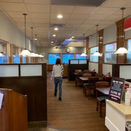 a woman walking through a restaurant a woman walking through a restaurant