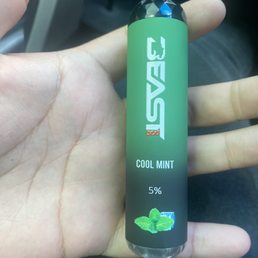 a hand holding a bottle of cool mint