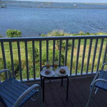Waterside Motor Inn - Enjoying some nibbles from the complimentary breakfast on our balcony - Hotels Near Me - Chincoteague Island, Virginia Waterside Motor Inn - Enjoying some nibbles from the complimentary breakfast on our balcony - Hotels Near Me - Chincoteague Island, Virginia