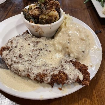 TJ'S At The Old Forge - Pecan crusted chicken with mashed potatoes and fried brussel sprouts - Steakhouses Near Me - Bandera, Texas TJ'S At The Old Forge - Pecan crusted chicken with mashed potatoes and fried brussel sprouts - Steakhouses Near Me - Bandera, Texas