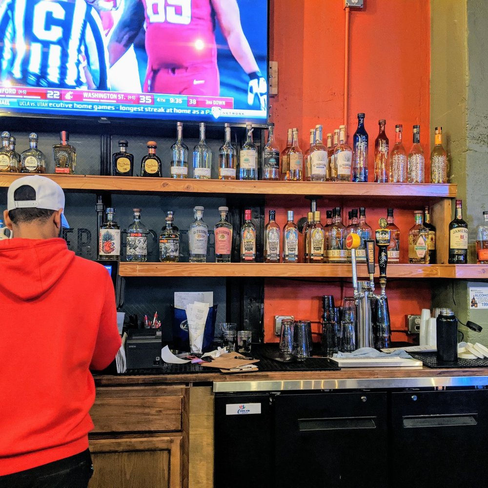 Pioneer - a man in a red hoodie at a bar - Bars Near Me - Seattle, Washington Pioneer - a man in a red hoodie at a bar - Bars Near Me - Seattle, Washington