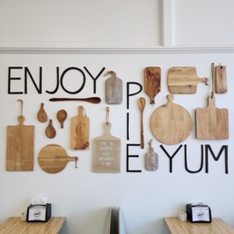 a variety of cutting boards and utensils on a wall a variety of cutting boards and utensils on a wall