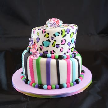 Fanny Cakes - a multi - colored cake on a pink plate - Desserts Near Me - Nesconset, New York