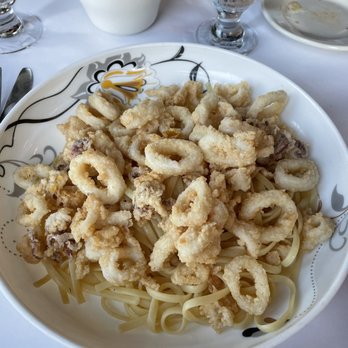 Guy Anthony's - Fried calamari over linguine with garlic and oil. So crispy and yet incredibly tender. - Italian Near Me - North Merrick, New York Guy Anthony's - Fried calamari over linguine with garlic and oil. So crispy and yet incredibly tender. - Italian Near Me - North Merrick, New York