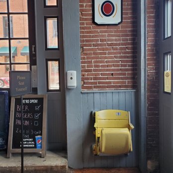 1869 Draft Room - a yellow chair and a sign - Sports Bars Near Me - Washington, Missouri