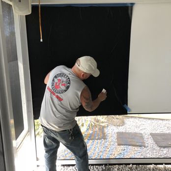 Silverback Screening - Me applying a 3M vinyl to give that movie theater feel to the projector retractable screen - Awnings Near Me - Wimauma, Florida