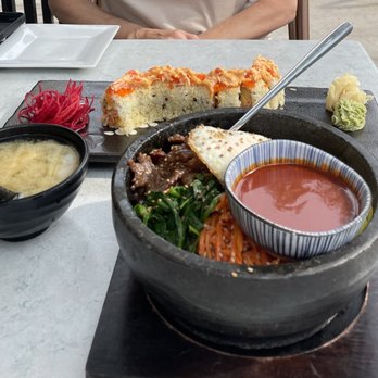 Sushi Mura - a man sitting at a table with a bowl of sushi and a bowl of soup - Sushi Bars Near Me - Chicago, Illinois Sushi Mura - a man sitting at a table with a bowl of sushi and a bowl of soup - Sushi Bars Near Me - Chicago, Illinois
