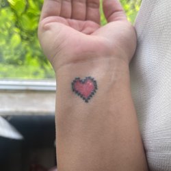 Gothic City Tattoos - "Legend of Zelda Heart"  Only a week old looks like a temporary tat w patchy shading Line-work is alright but also patchy in places