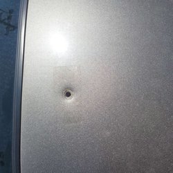 Community Garage of Madison - Bullet hole