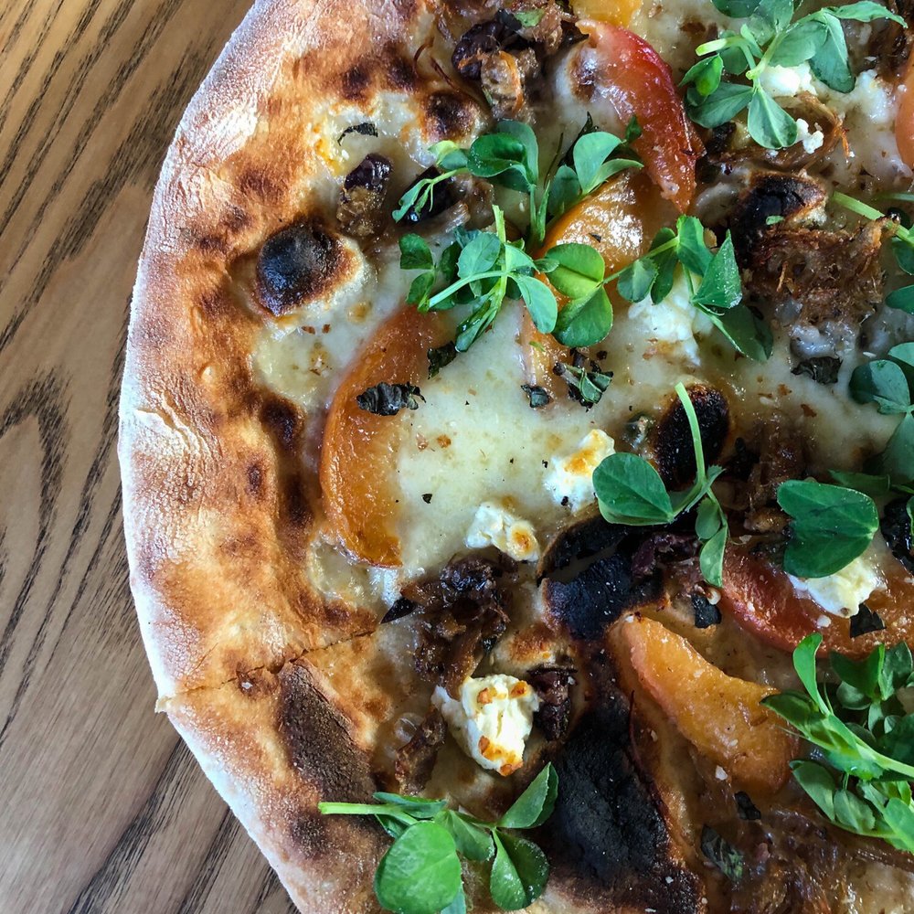 Duck confit, fior di latte, grilled peach, feta, pea shoots, pecorino, grana, honey, almond, mint
