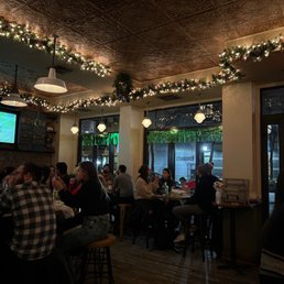 people sitting at tables in a restaurant people sitting at tables in a restaurant