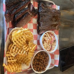 Brisket, ribs, spicy coleslaw, baked beans, Cajun waffle fries Brisket, ribs, spicy coleslaw, baked beans, Cajun waffle fries