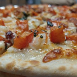 Wise Guys Pizza - The "Lobsta Mobsta" features a garlic butter base, fresh basil, diced tomatoes, LOBSTER and topped with Parmesan cheese!  A crowd favourite