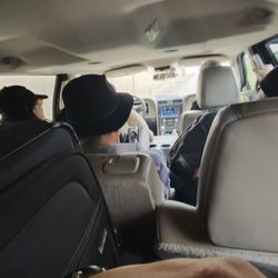 Texas Shuttle - A photo from my passenger showing how full the vehicles were. His suitcase is on his lap.