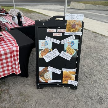 Pinoy Cravings - a table set up with a menu board - Pop-Up Restaurants Near Me - Lakeland, Florida