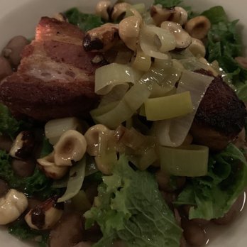 Le Pichet - Crispy pork belly with beans, hazelnuts, leeks, and mustard greens - French Near Me - Seattle, Washington Le Pichet - Crispy pork belly with beans, hazelnuts, leeks, and mustard greens - French Near Me - Seattle, Washington