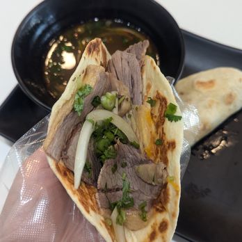 Soufend Cafe & Eatery - Bún Bò Huế Tacos: Flour tortilla, cheese, beef topped with basil, beansprout, onion, cilantro onions served with a spicy beef noodle consome - Cafes Near Me - Seattle, Washington